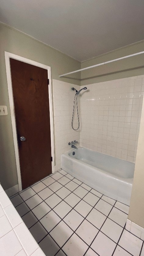 bathroom with tile patterned floors and washtub / shower combination
