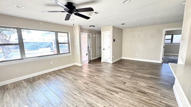 interior space with hardwood / wood-style floors, a textured ceiling, and ceiling fan