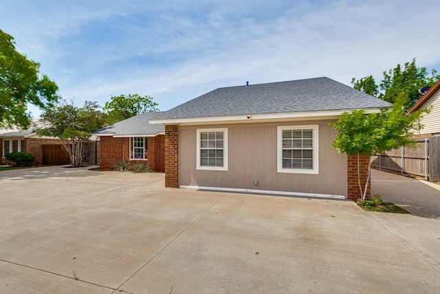 4503 Palmer Dr, Midland, TX 79705 - back of property with a shingled roof and a patio area