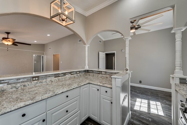 4503 Palmer Dr, Midland, TX 79705 - kitchen with a ceiling fan, arched walkways, decorative columns, white cabinetry, and ornamental molding