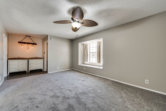 4503 Palmer Dr, Midland, TX 79705 - unfurnished bedroom featuring dark carpet, a textured ceiling, and ceiling fan