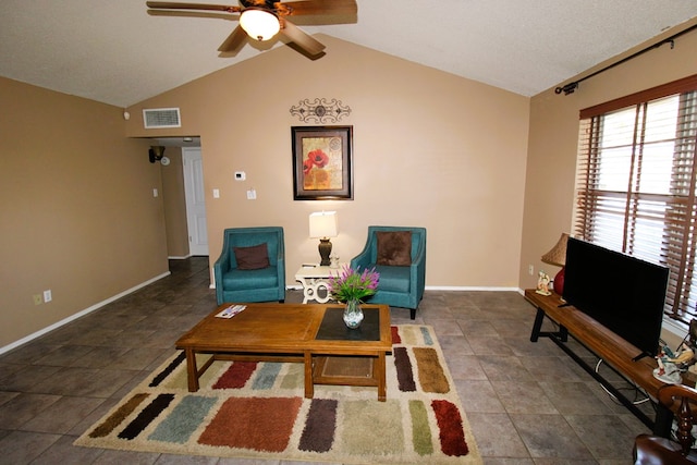 living area with a ceiling fan, vaulted ceiling, and baseboards