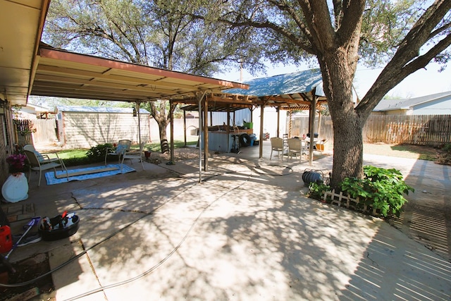 view of patio / terrace featuring a fenced backyard, a covered hot tub, and a gazebo