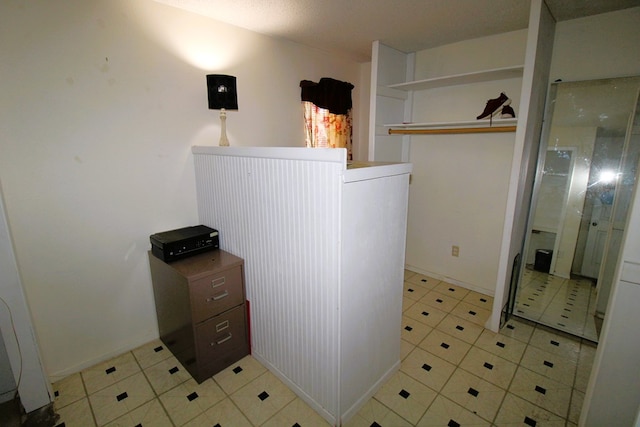 laundry area with light tile patterned floors