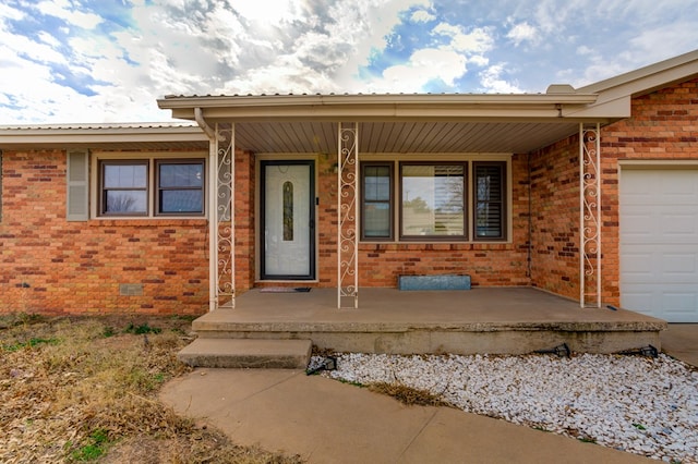 entrance to property with a garage and a porch