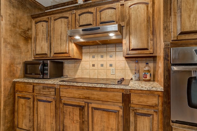 kitchen with stainless steel appliances and decorative backsplash