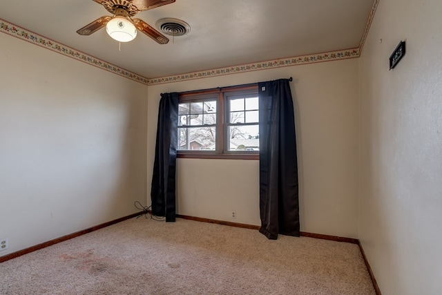 empty room featuring light carpet and ceiling fan