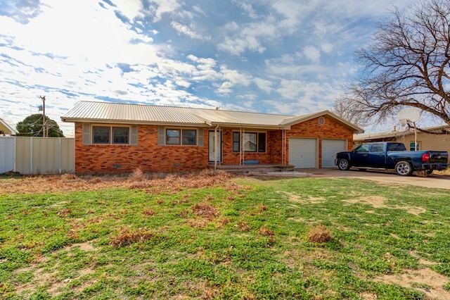 ranch-style home featuring a front lawn and a garage