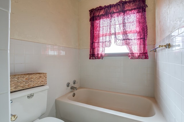 bathroom featuring a tub and toilet