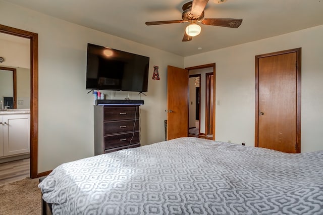 carpeted bedroom featuring ceiling fan and connected bathroom