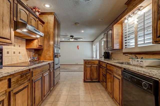 kitchen featuring sink, a textured ceiling, light carpet, ceiling fan, and black appliances