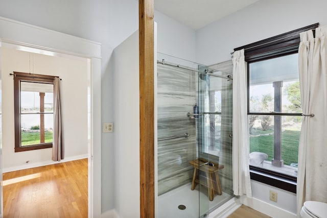 101 N 7th St, Marathon, TX 79842 - full bathroom featuring a stall shower, baseboards, and wood finished floors