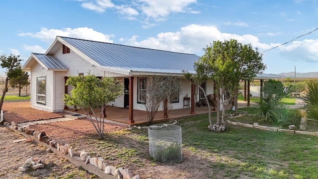 101 N 7th St, Marathon, TX 79842 - view of front of home with metal roof, covered porch, a front yard, and a mountain view