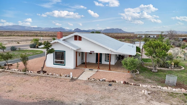 101 N 7th St, Marathon, TX 79842 - view of front of house featuring a porch, a mountain view, and a chimney