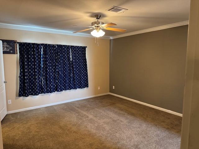 carpeted empty room featuring visible vents, a ceiling fan, baseboards, and ornamental molding
