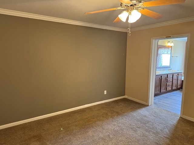 empty room with crown molding, baseboards, dark carpet, and ceiling fan