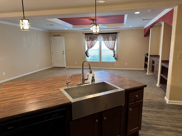 kitchen featuring crown molding, open floor plan, black dishwasher, a tray ceiling, and a sink
