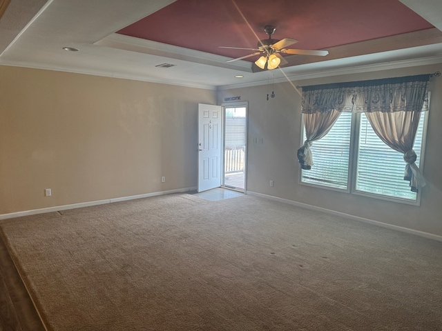 spare room with baseboards, ceiling fan, carpet, and a tray ceiling