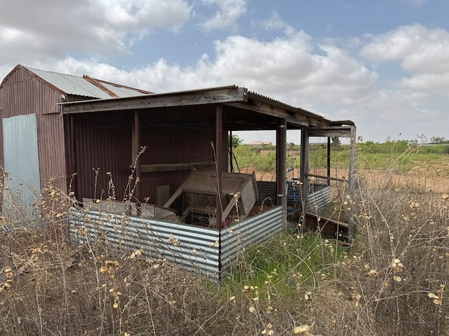exterior space featuring an outdoor structure, exterior structure, and metal roof