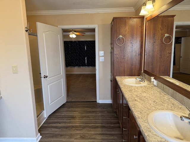 bathroom with baseboards, ornamental molding, and a sink