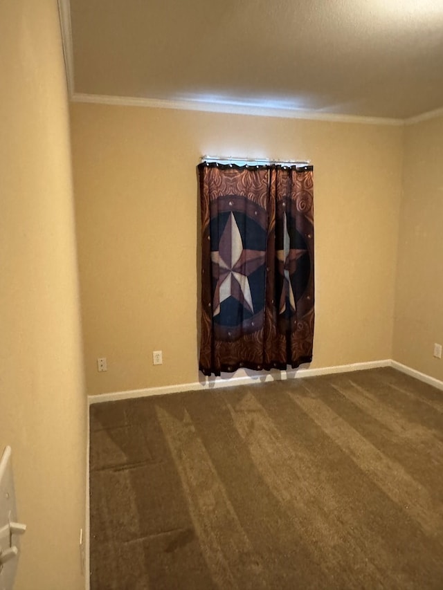 carpeted spare room with baseboards and ornamental molding