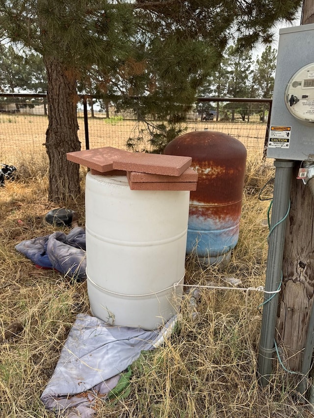 exterior details featuring fence and electric meter