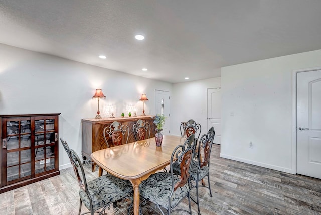 dining space featuring hardwood / wood-style floors and a textured ceiling