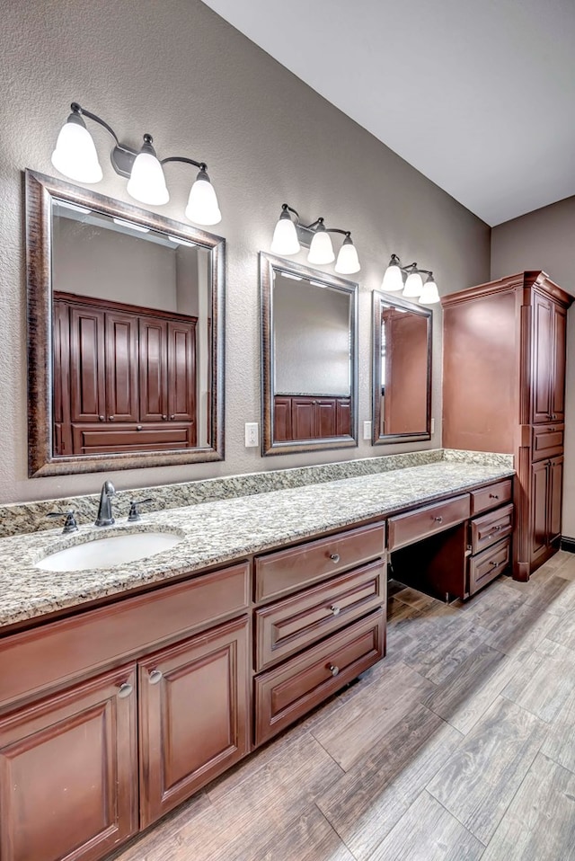 bathroom featuring hardwood / wood-style flooring and vanity