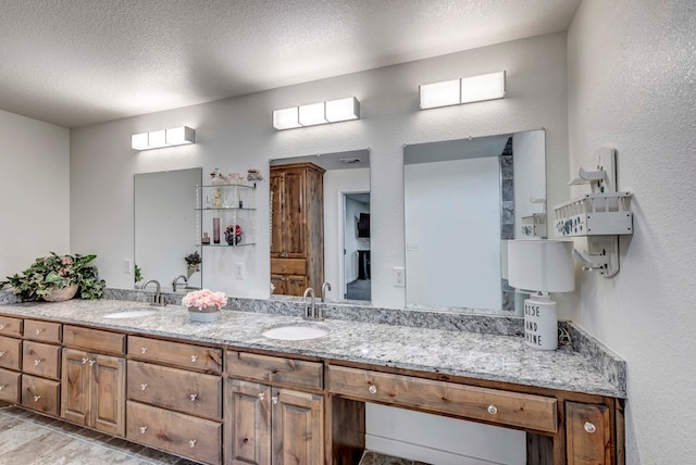 bathroom with vanity and a textured ceiling