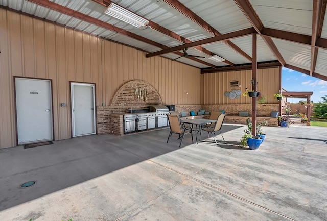 view of patio with area for grilling and ceiling fan