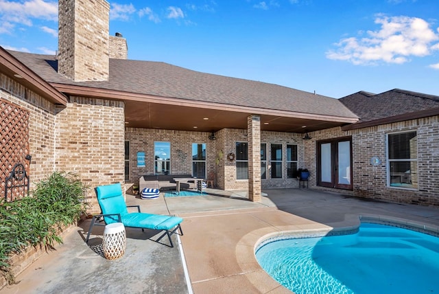 view of swimming pool with a patio area, outdoor lounge area, and french doors