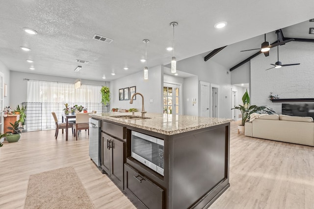 6338 Mecca St, Odessa, TX 79762 - kitchen featuring appliances with stainless steel finishes, light wood-style flooring, vaulted ceiling, a ceiling fan, and hanging light fixtures