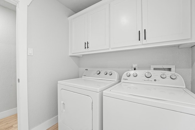 6338 Mecca St, Odessa, TX 79762 - washroom with cabinet space, washer and clothes dryer, and light wood-style flooring