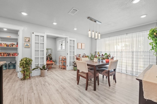 6338 Mecca St, Odessa, TX 79762 - dining space featuring light wood finished floors, a textured ceiling, french doors, and recessed lighting