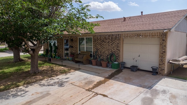 1703 Hemphill Ave, Odessa, TX 79763 - ranch-style home with a shingled roof, a garage, driveway, and brick siding