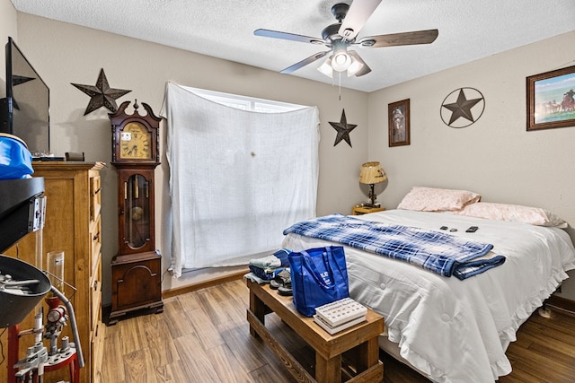 1703 Hemphill Ave, Odessa, TX 79763 - bedroom with wood finished floors, a textured ceiling, and a ceiling fan