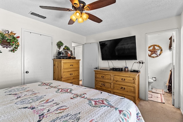 1703 Hemphill Ave, Odessa, TX 79763 - bedroom with carpet flooring, a textured ceiling, ceiling fan, ensuite bathroom, and a closet