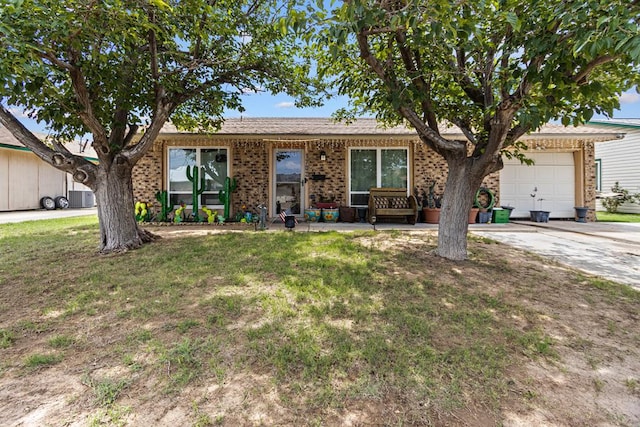 1703 Hemphill Ave, Odessa, TX 79763 - ranch-style home with a front yard, an attached garage, concrete driveway, and brick siding