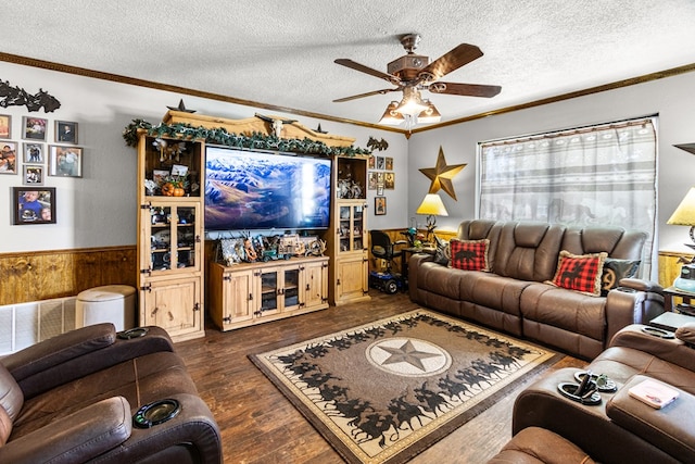 1703 Hemphill Ave, Odessa, TX 79763 - living room featuring wainscoting, a textured ceiling, ceiling fan, dark wood-style floors, and wood walls
