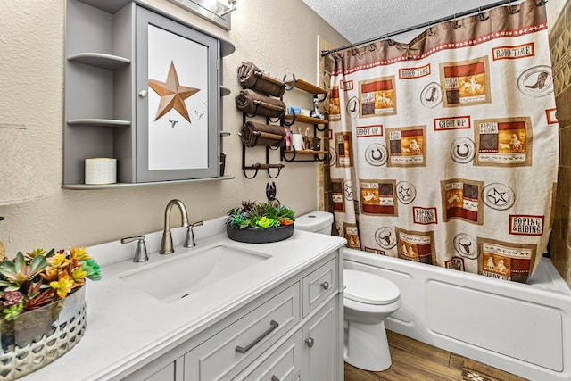 1703 Hemphill Ave, Odessa, TX 79763 - bathroom featuring vanity, a textured wall, wood finished floors, a textured ceiling, and shower / bathtub combination with curtain