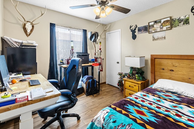1703 Hemphill Ave, Odessa, TX 79763 - bedroom featuring wood finished floors, an office area, ceiling fan, and a textured ceiling