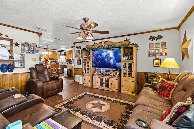 1703 Hemphill Ave, Odessa, TX 79763 - living room featuring wainscoting, ceiling fan, wood finished floors, a textured ceiling, and ornamental molding