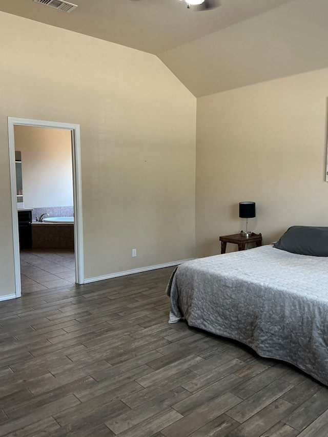 2804 Anice St, Odessa, TX 79762 - bedroom featuring vaulted ceiling, dark wood-type flooring, baseboards, and ensuite bath