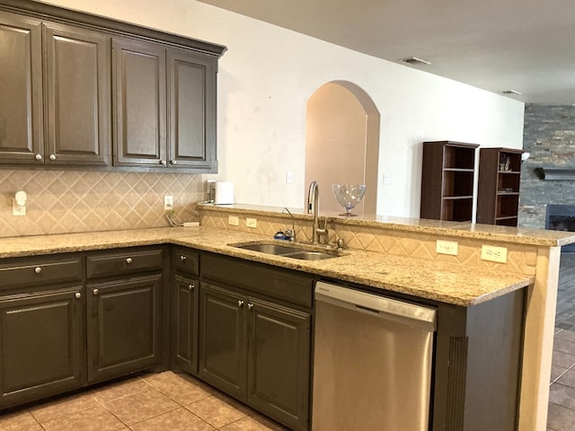 2804 Anice St, Odessa, TX 79762 - kitchen with dishwasher, a sink, a peninsula, light tile patterned flooring, and arched walkways