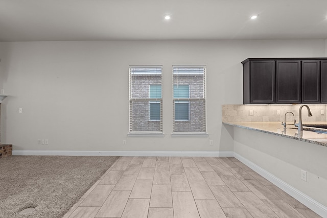 8901 Ratliff Ridge Ave, Odessa, TX 79765 - kitchen with backsplash, light stone countertops, and recessed lighting