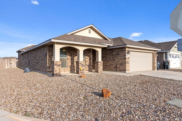 8901 Ratliff Ridge Ave, Odessa, TX 79765 - ranch-style home featuring brick siding, a porch, concrete driveway, an attached garage, and roof with shingles