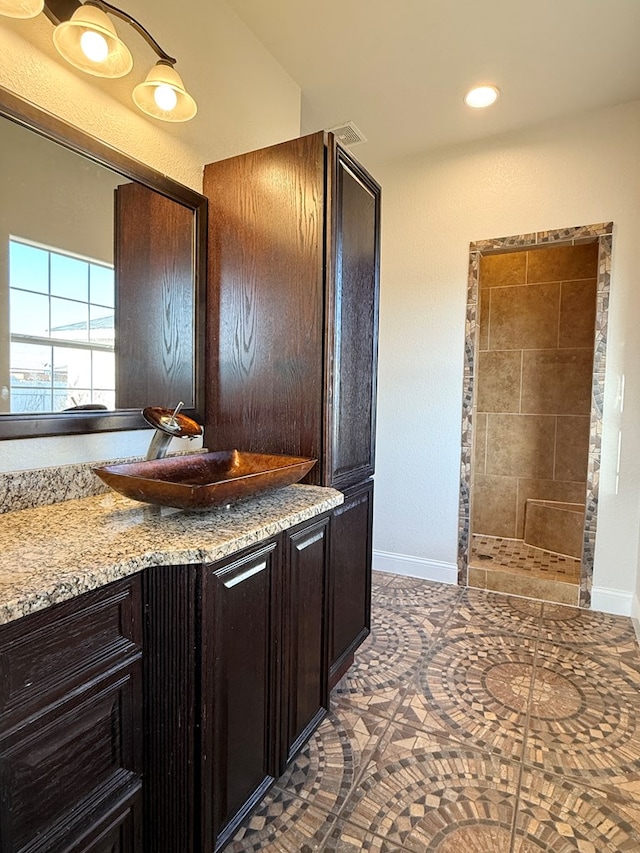 bathroom with recessed lighting, baseboards, and vanity