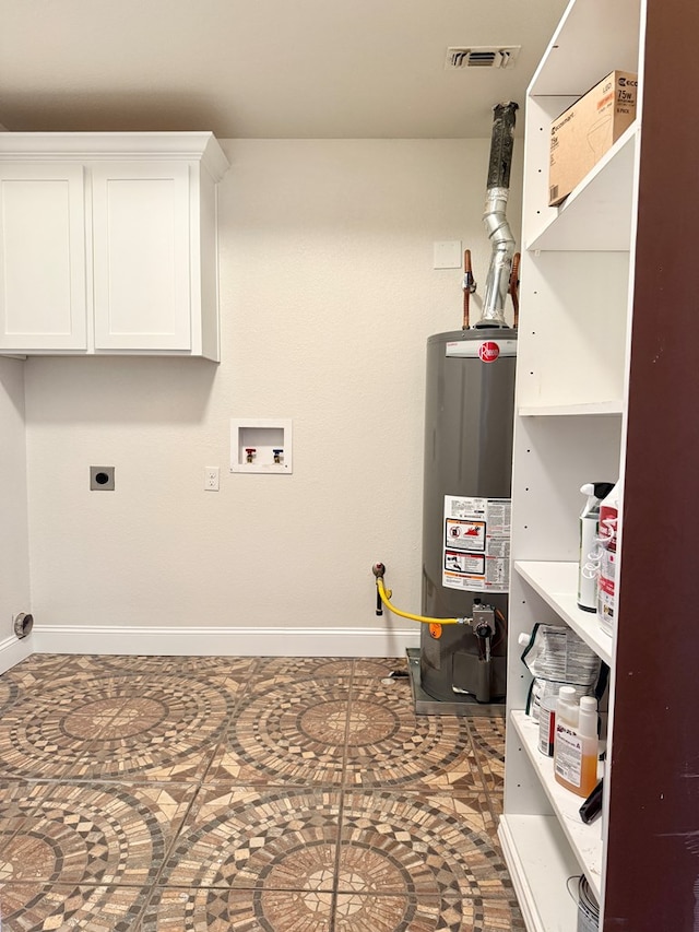 utility room featuring gas water heater and visible vents