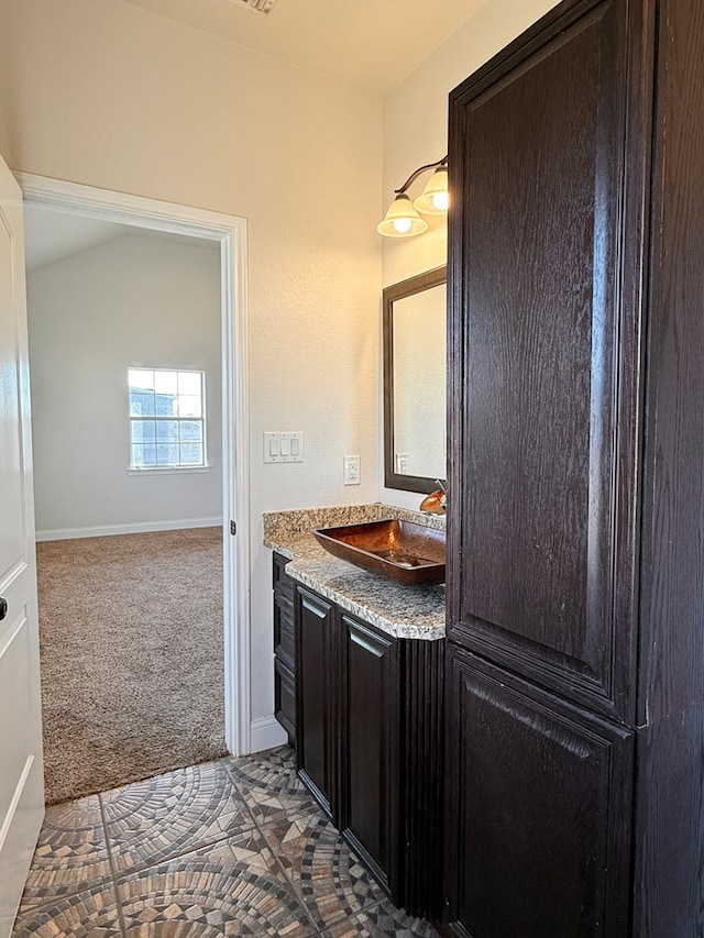 bathroom featuring vanity and baseboards