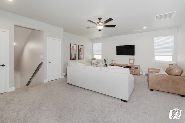 living area with visible vents, recessed lighting, ceiling fan, and light colored carpet